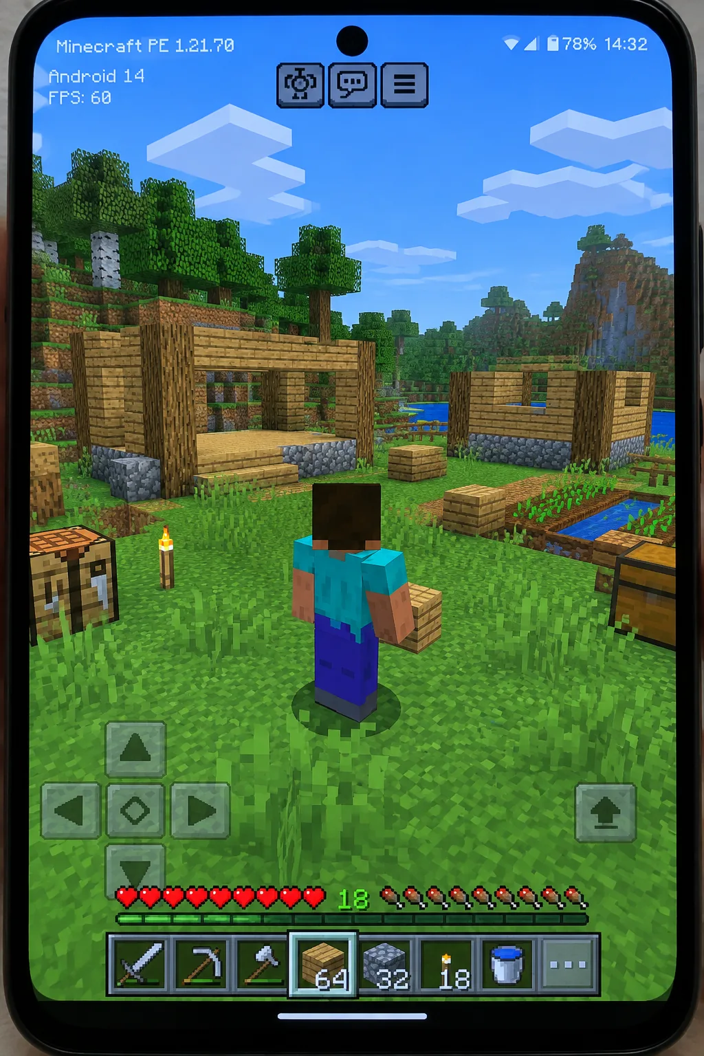 Màn hình điện thoại chạy Minecraft PE 1.21.70, người chơi xây nhà gỗ trên đất cỏ có cây